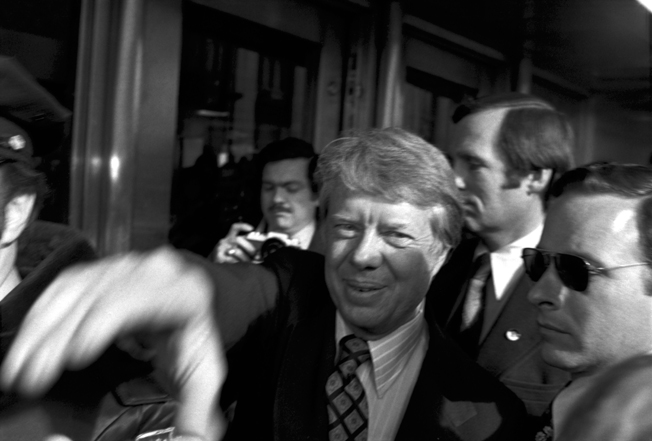 Soon to become, U.S. President jimmy Carter reaching out to photographer steve landis